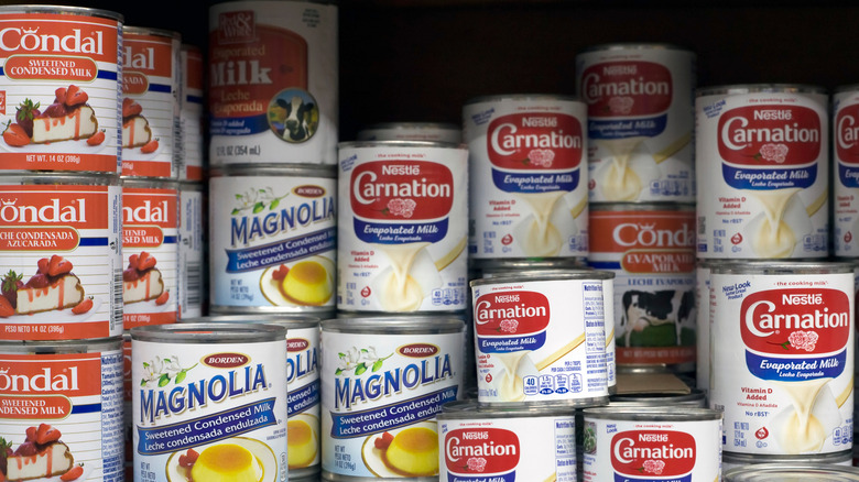 Cans of condensed milk on store shelf