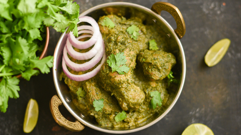 Pot of green curry with meat and coriander