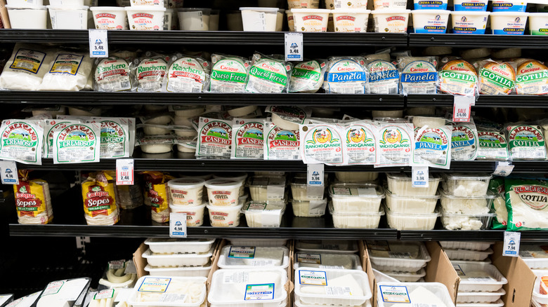 Grocery store aisle with various Mexican cheeses