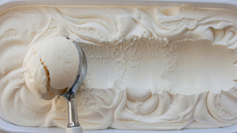 scooping vanilla ice cream