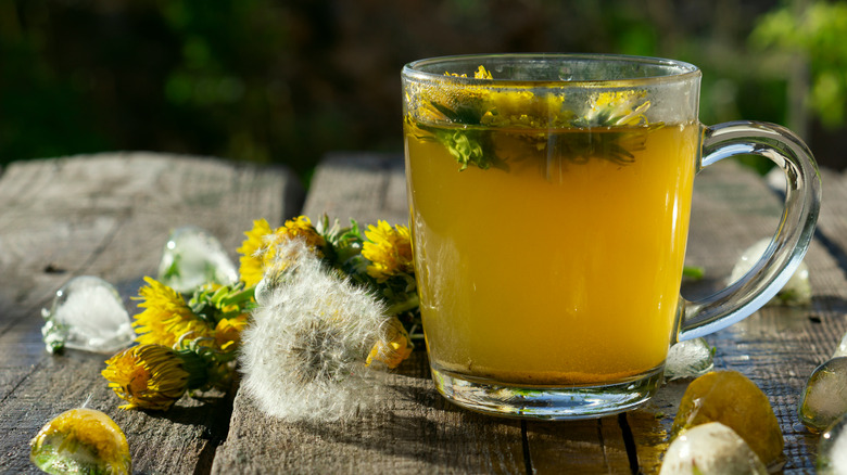 Dandelion tea in a glass mug