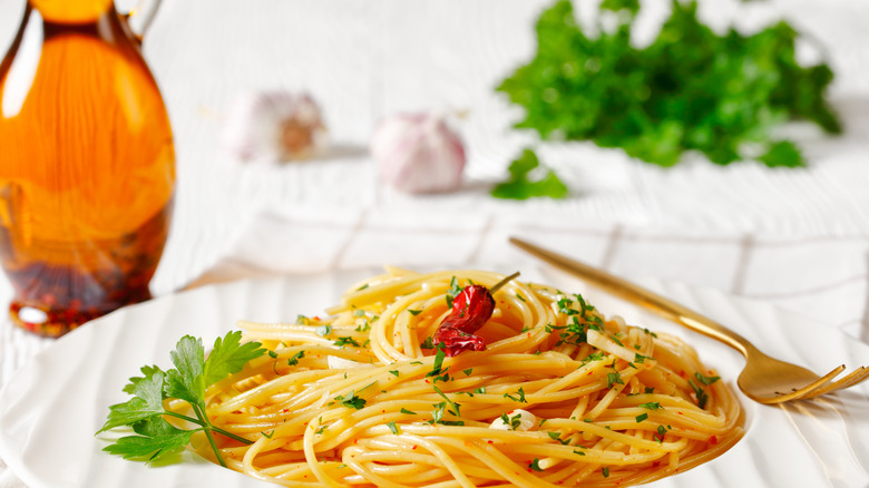 Spaghetti with colatura di alici in the background