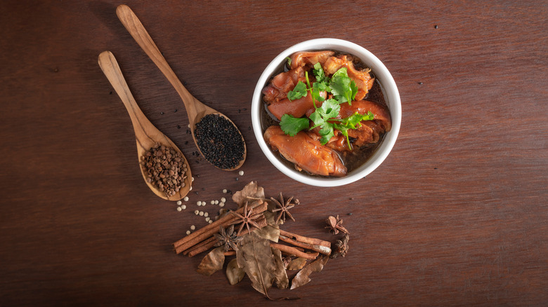 Bowl of stew with various ingredients on wooden tabletop