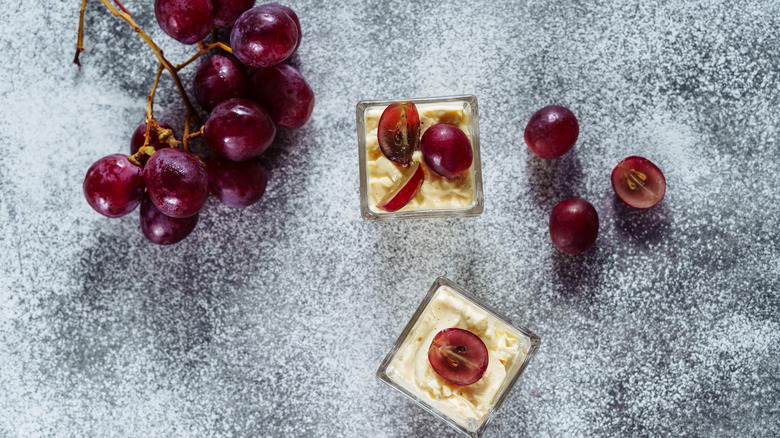 Flummery in glass containers topped with grapes