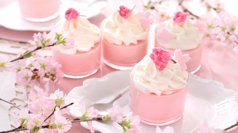 Cherry blossom mousse dessert with whipped cream in glasses. Home made glass dessert with beautiful cherry blossom.