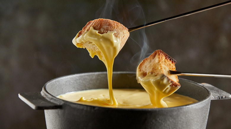 Fondue dipped against a black background
