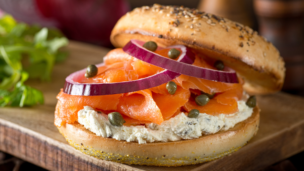 Toasted bagel with salmon, cream cheese, capers, and onion slices