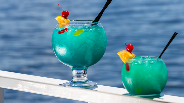 blue fishbowl cocktails with water background