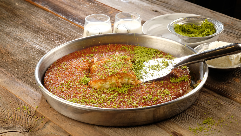 Kunafa being lifted out of a pan