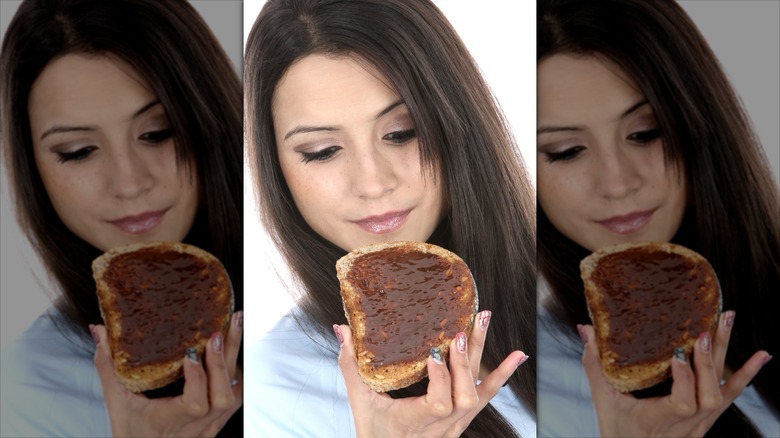 Person eating Marmite on toast