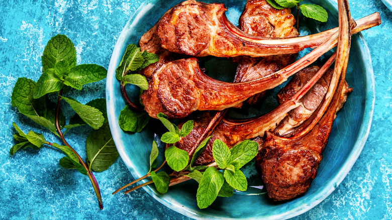 Lamb chops on blue plate with mint