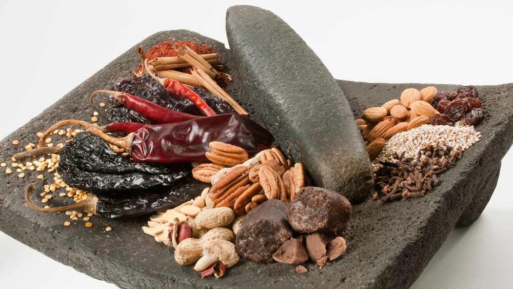 Ingredients to make mole on a mortar and pestle