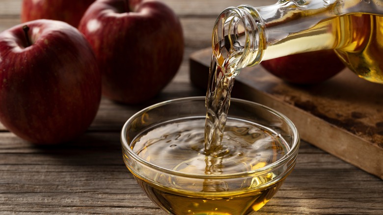 Pouring apple cider vinegar