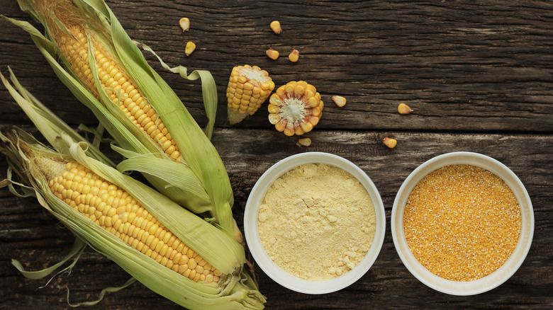 Polenta next to corn stalks on wood table