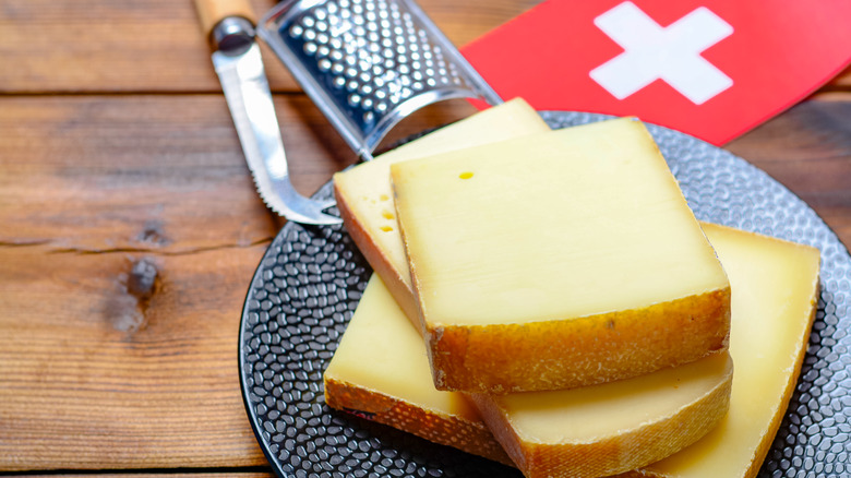 Blocks of cheese with Swiss flag in background