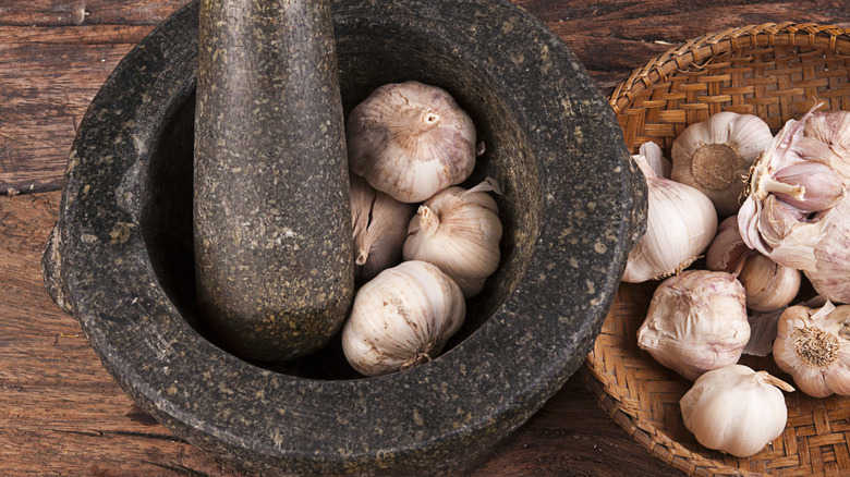 Garlic bulbs in a mortar and pestle
