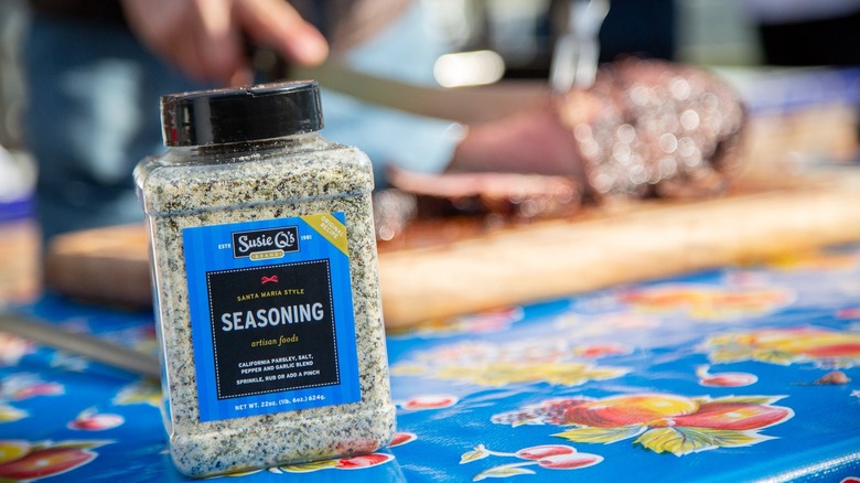 Susie Q's seasoning with meat in background 