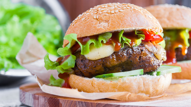 Seitan burger on toasted sesame bun with lettuce and ketchup