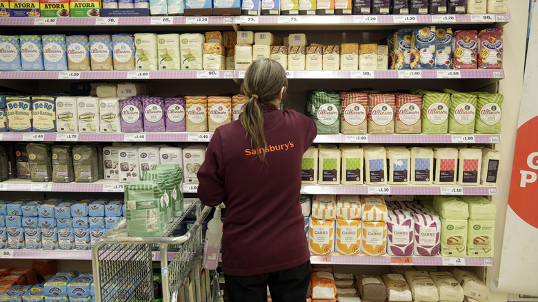 supermarket employee in flour aisle