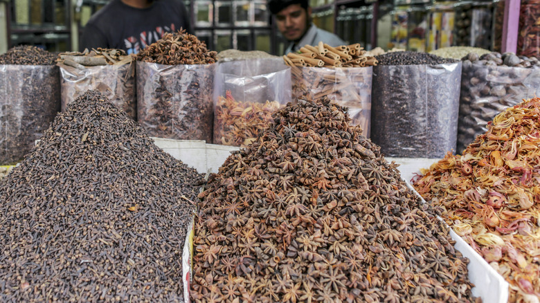 Star anise among other spices at an outdoor market