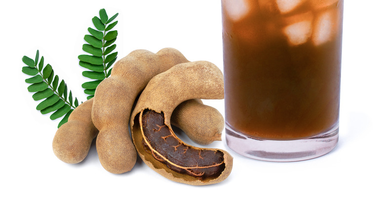 tamarind juice with ice in glass by tamarind raw