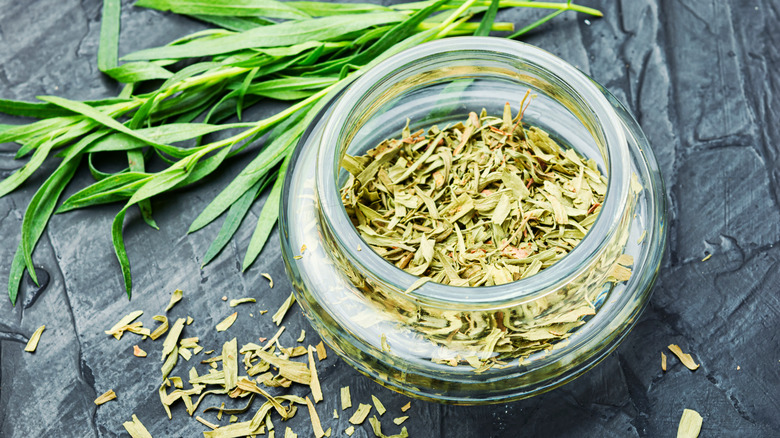 Dried tarragon in a glass container