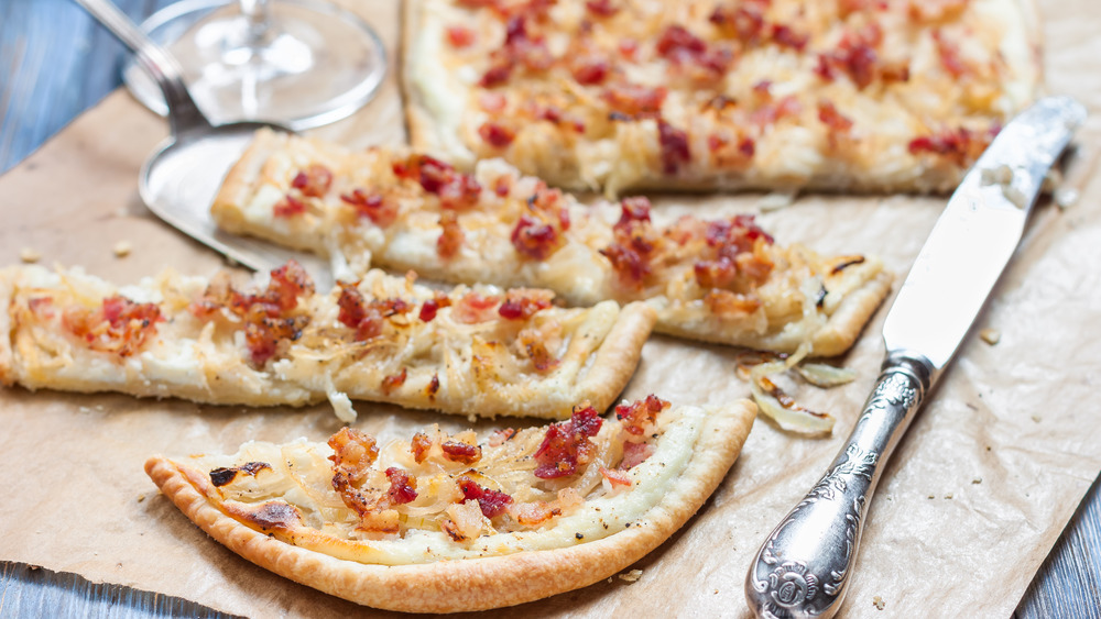 Tarte flambée next to a butter knife