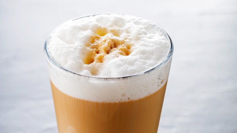 Foamy macchiato in glass mug