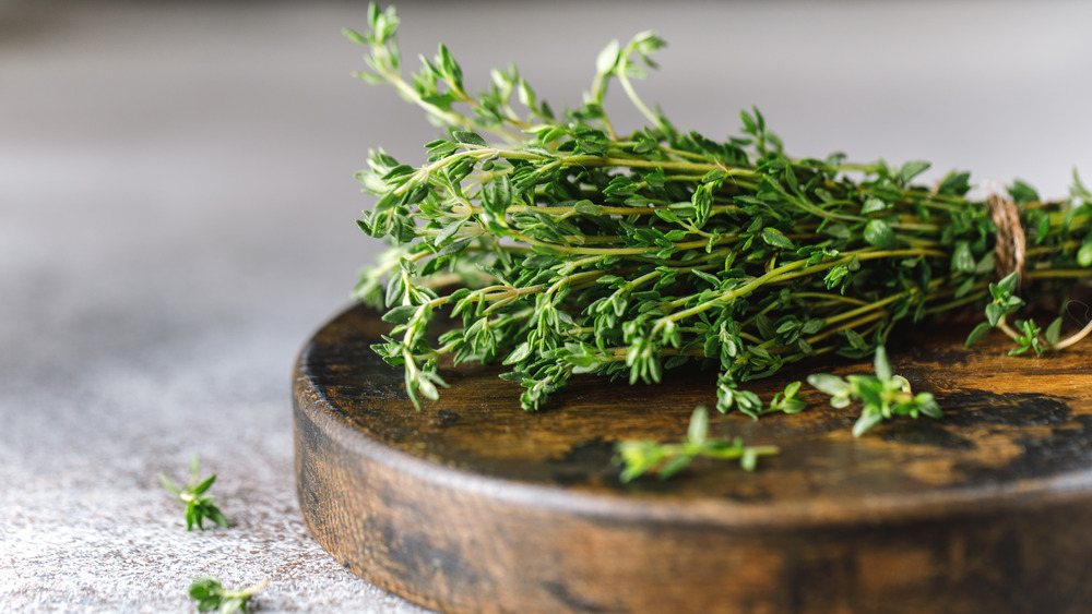 Bunch of fresh thyme on wooden platform