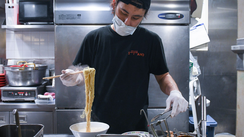 Chef preparing ramen bowl