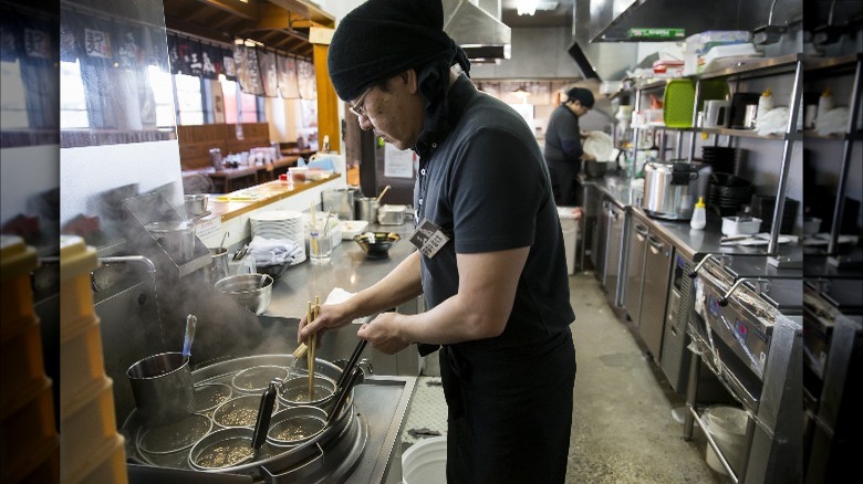 Chef making ramen in restaurant