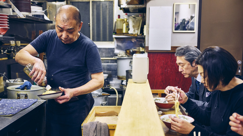 Ramen shop owner preparing food