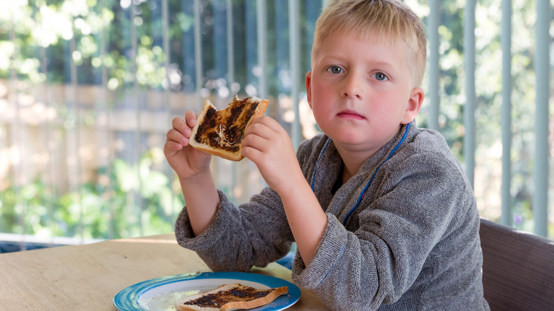 boy not thrilled with vegemite