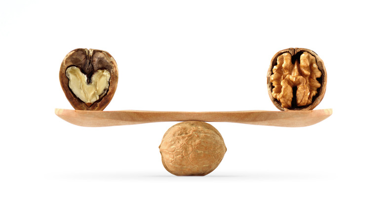 Two walnut halves balanced on a spoon