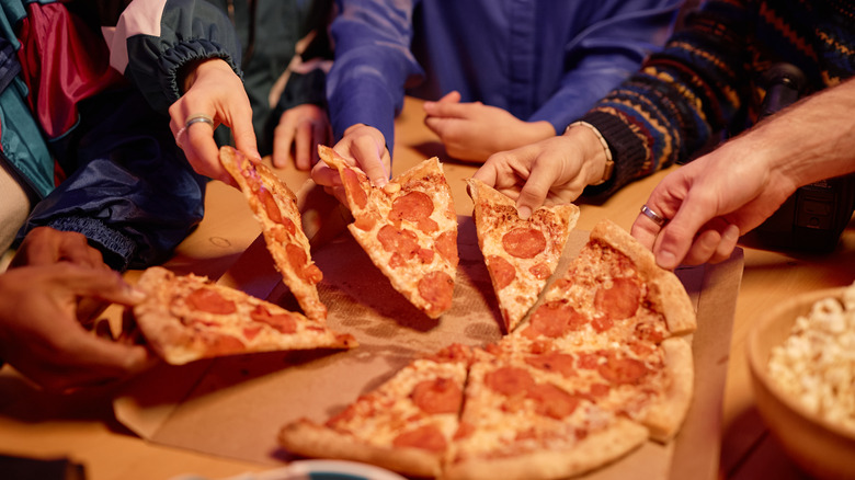 young people sharing pizza