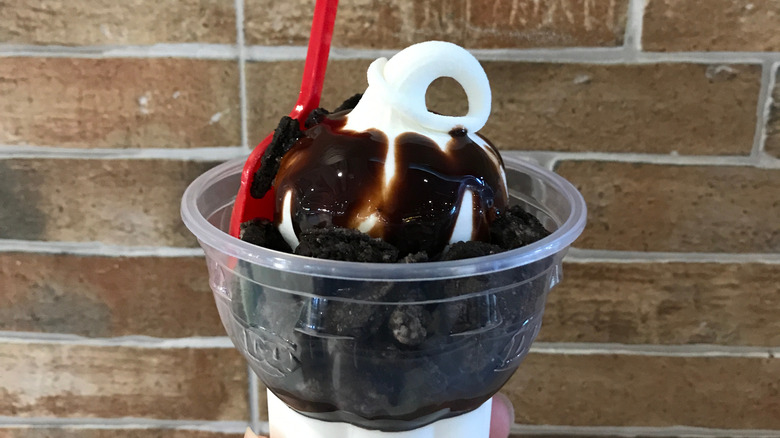 Dairy Queen sundae with crumbled cookies in plastic cup