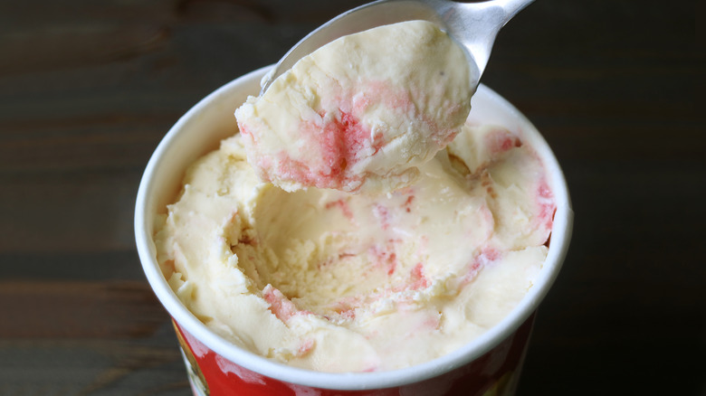 small carton of ice cream with spoon