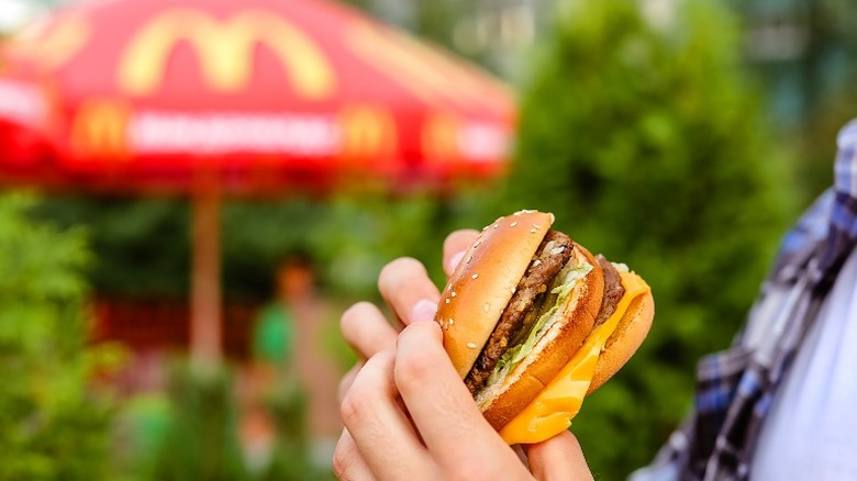 A person eating McDonald's hamburger