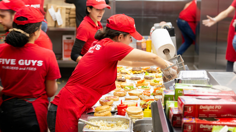 Five Guys staff prepping burgers