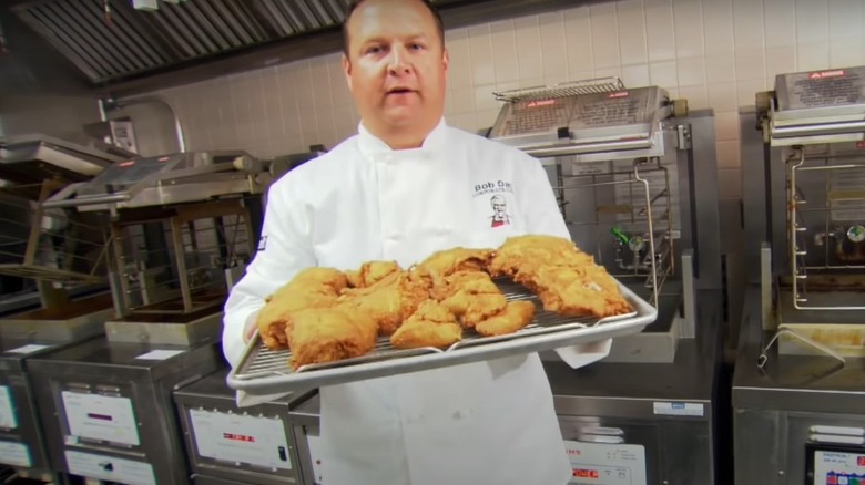 Man holds KFC chicken tray