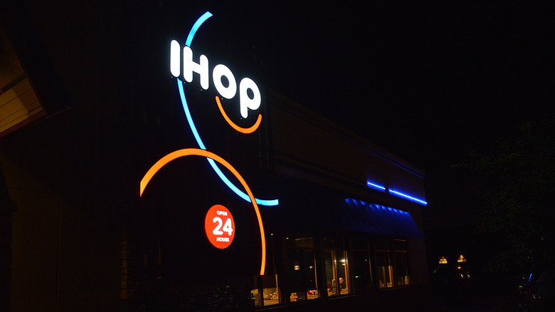 A neon IHOP sign at night