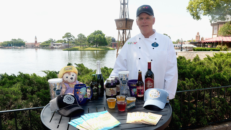 A disney chef with a special selection of drinks and merchandise from an epcot festival