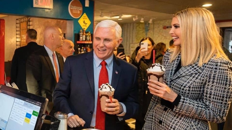 Former Vice President Mike Pence and First Daughter Ivanka Trump smile while holding milkshakes.