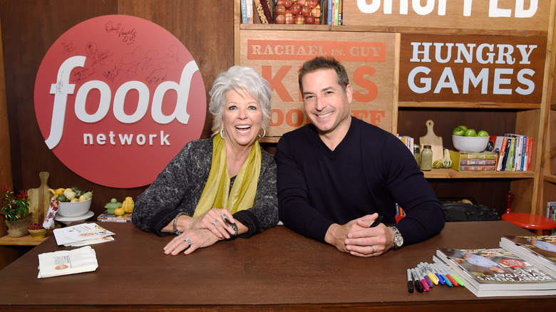 Paula and Bobby Deen smile for a photo at a book signing