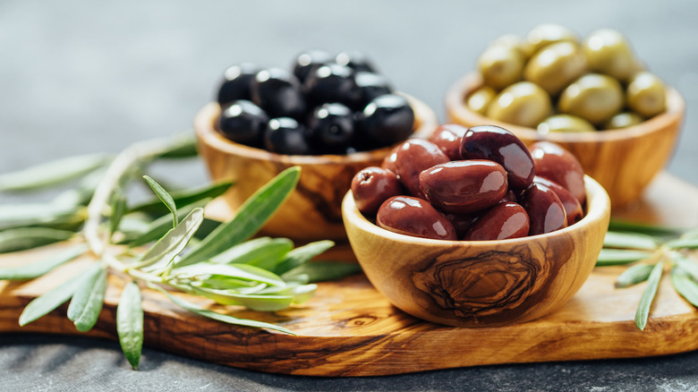 three types of olives in bowls