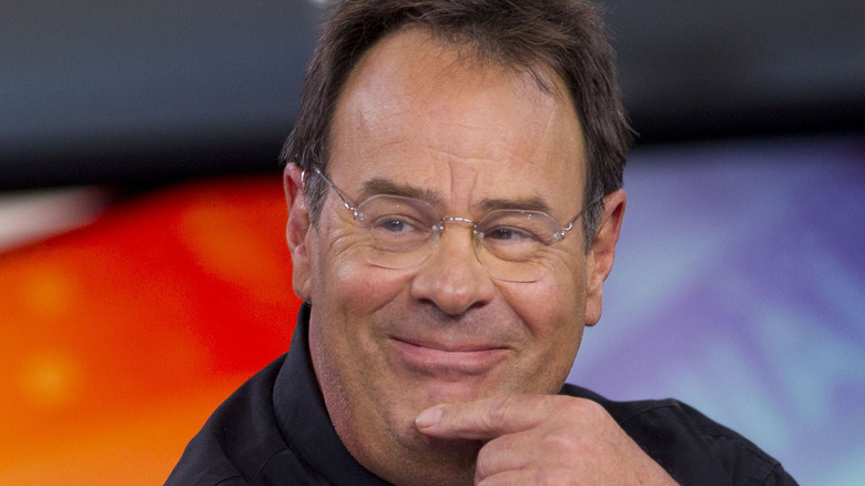 Dan Aykroyd with glasses and hand to chin