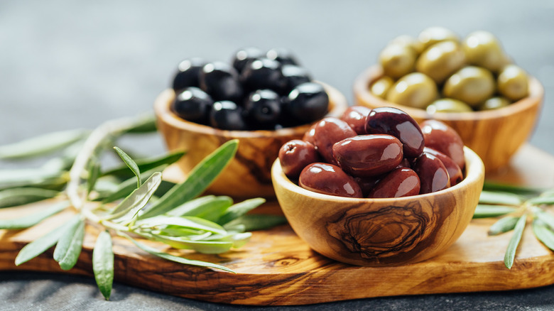 Three dishes of different olives