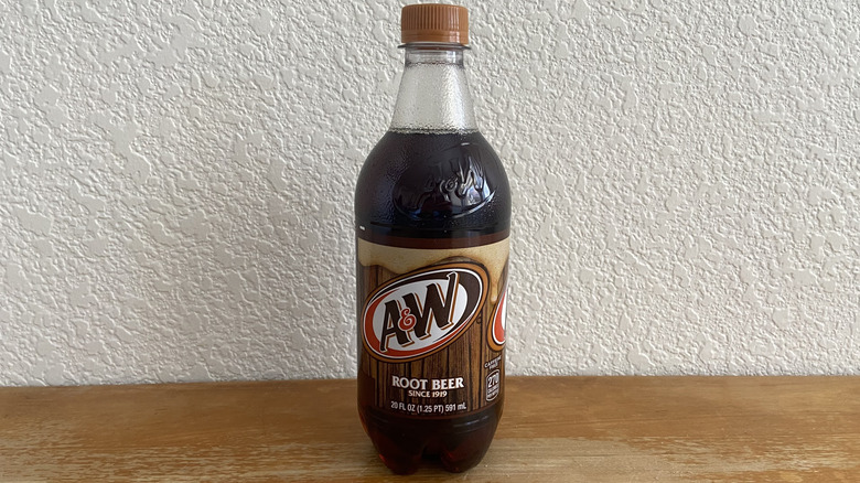 A&W root beer bottle on table