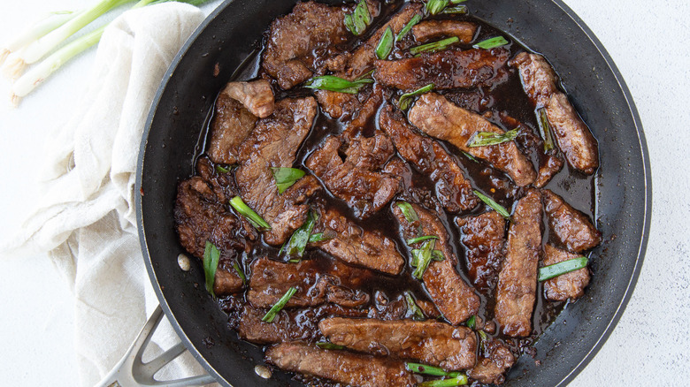 cooked steak strips in pan