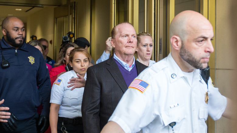 Mario Batali exiting court with security